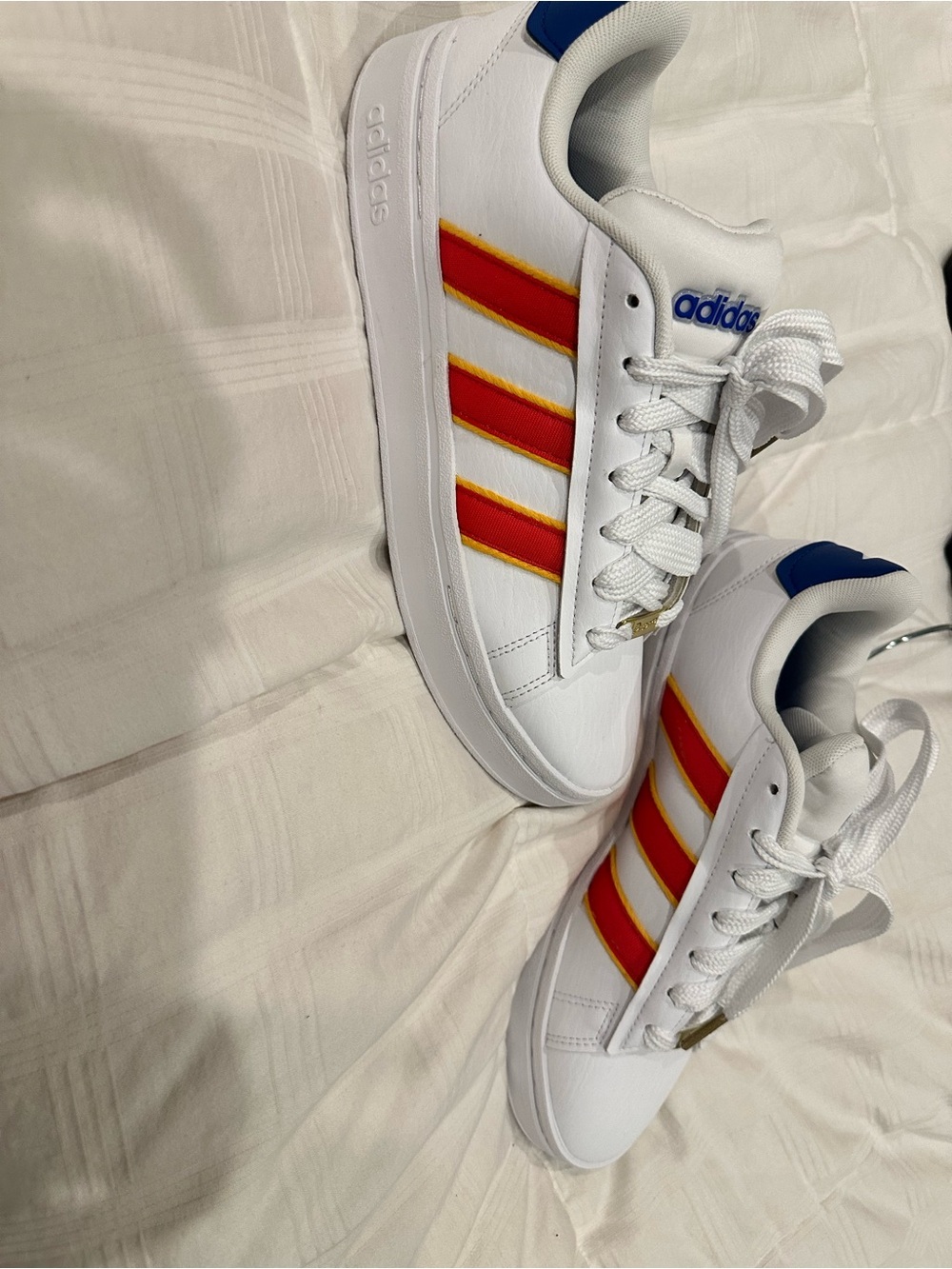 adidas Women’s White Sneakers with Red and Yellow Stripes and Blue Accents